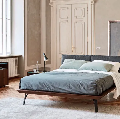 wooden embrace bed with shaped metal feet