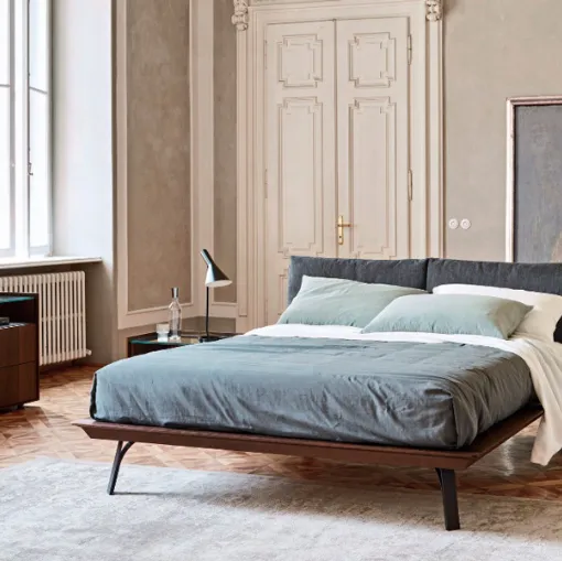 wooden embrace bed with shaped metal feet